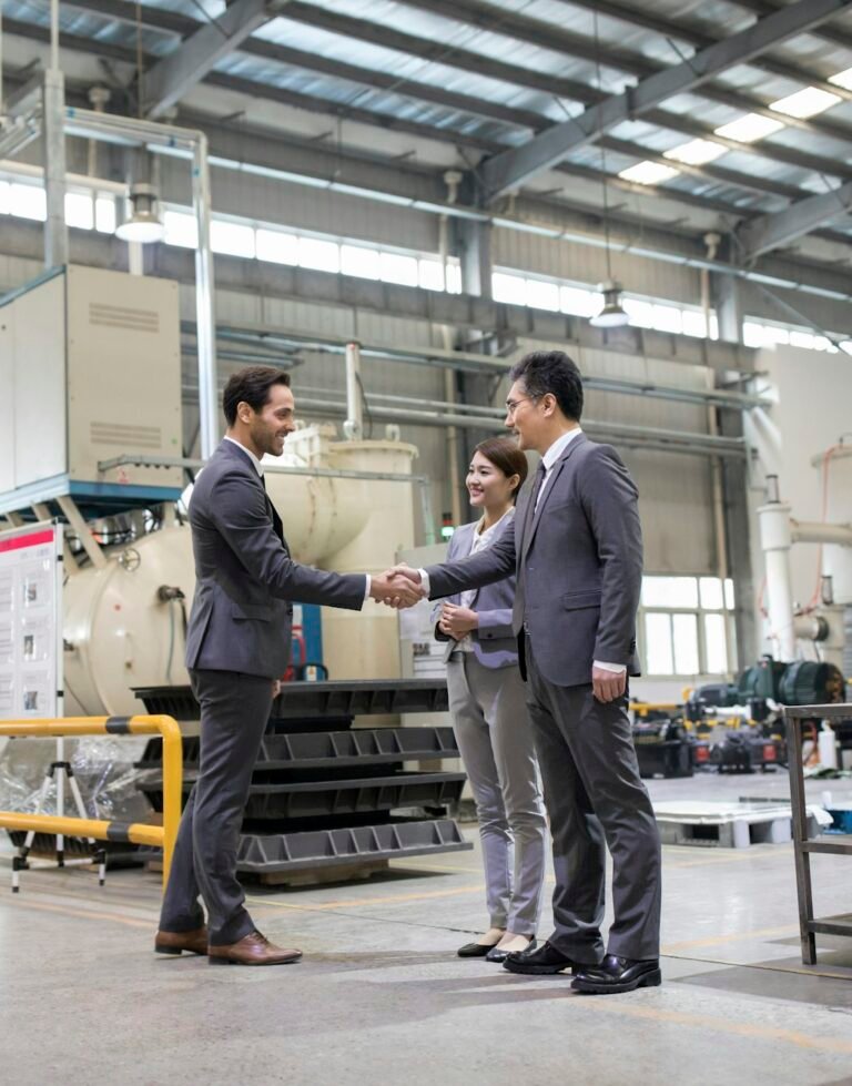 Business people shaking hands in the factory